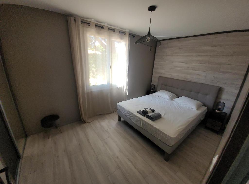 a bedroom with a bed with two shoes on it at T2 bord de mer - les embruns in Hyères