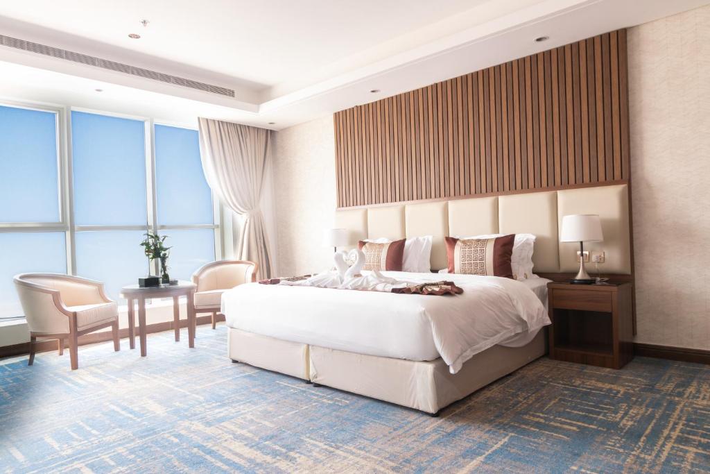 a bedroom with a large bed and a table and chairs at لابرادوريت in Jeddah