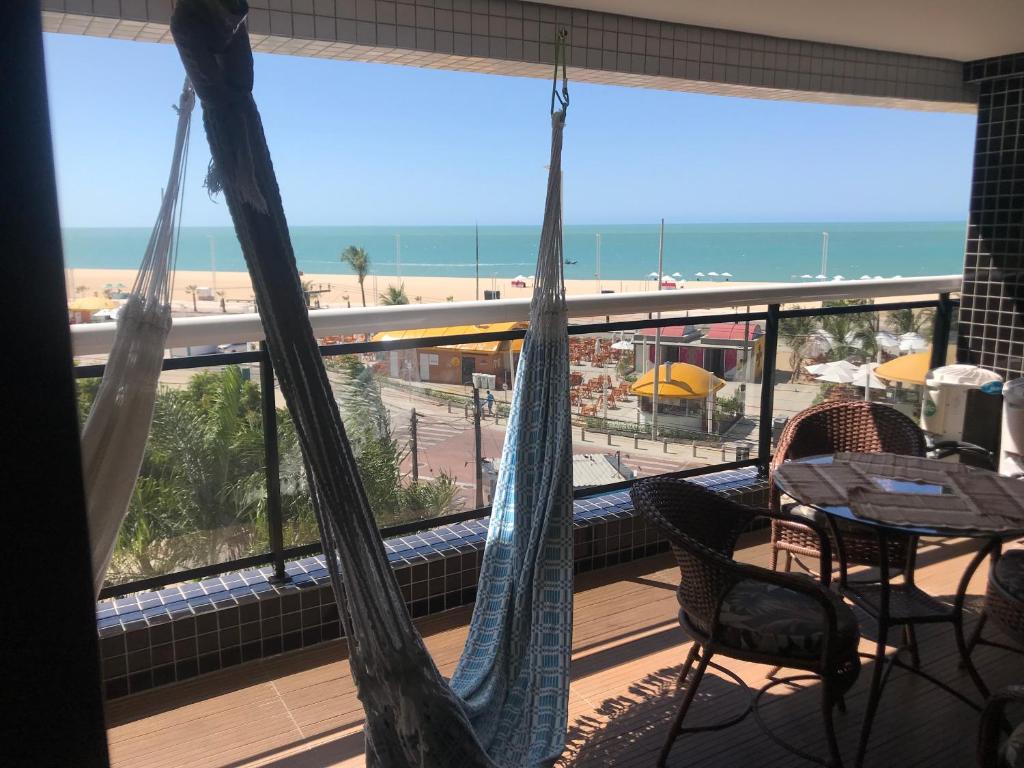 einen Balkon mit Hängematten und Strandblick in der Unterkunft Alugo Temporada apartamento frente ao mar de Fortaleza vista panorâmica do Mar in Fortaleza