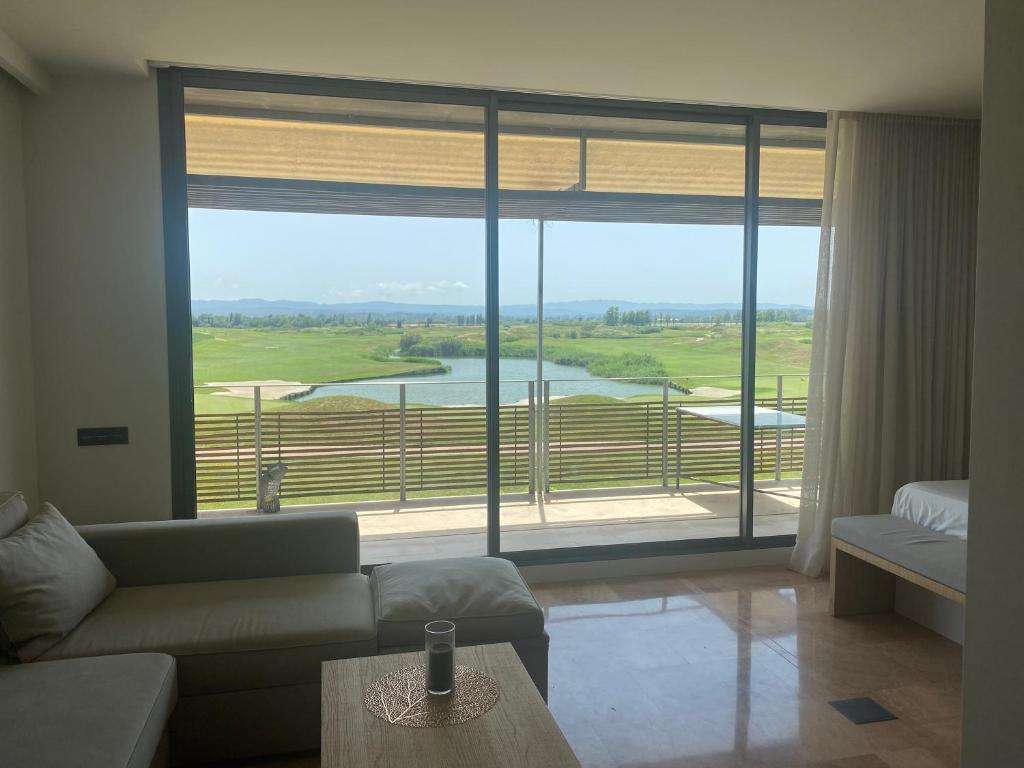 a living room with a couch and a large window at Moderno apartamento en Empordà Golf in Gualta