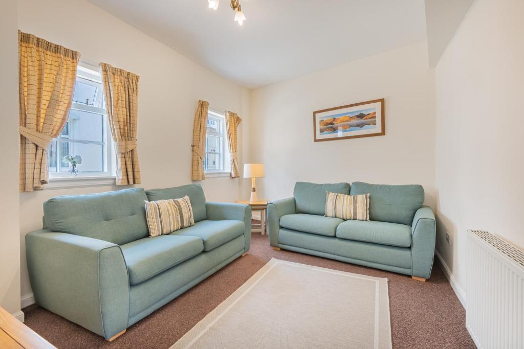 a living room with two chairs and a couch at Cottage 8 Old Farmhouse braithwaite in Keswick