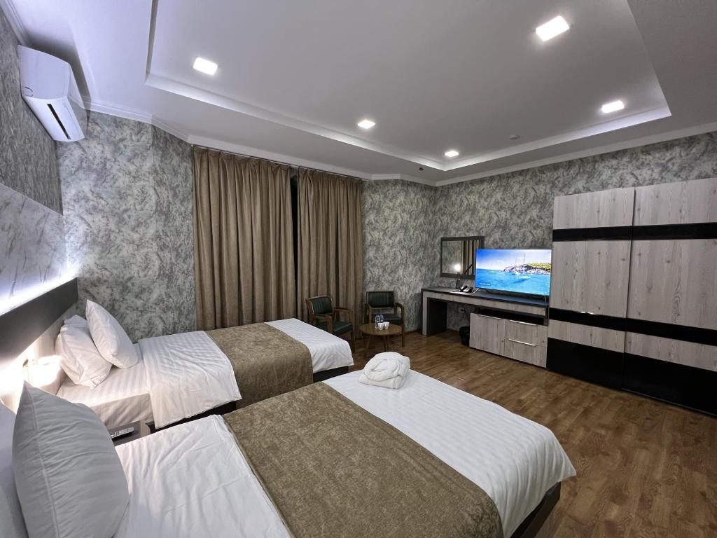 Postel nebo postele na pokoji v ubytování Ada Hotel