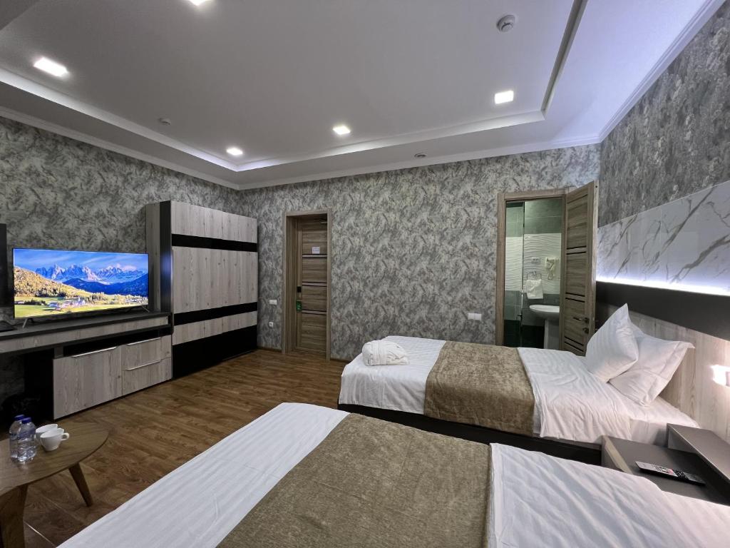 Postel nebo postele na pokoji v ubytování Ada Hotel