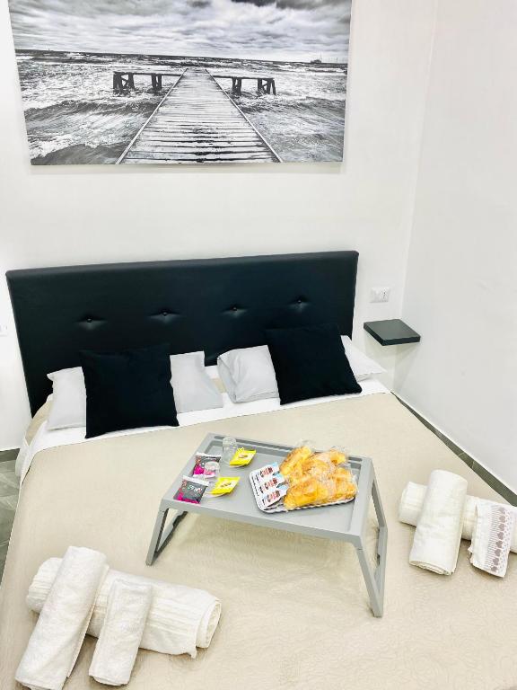 a bedroom with a bed with a tray of food on it at Toledo Home in Naples