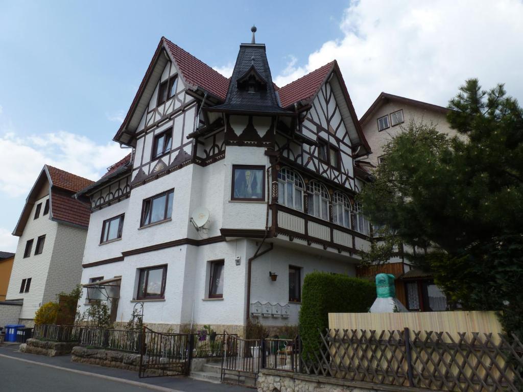 a large white house with a black and white at Ferienwohnung Grebner in Schalkau