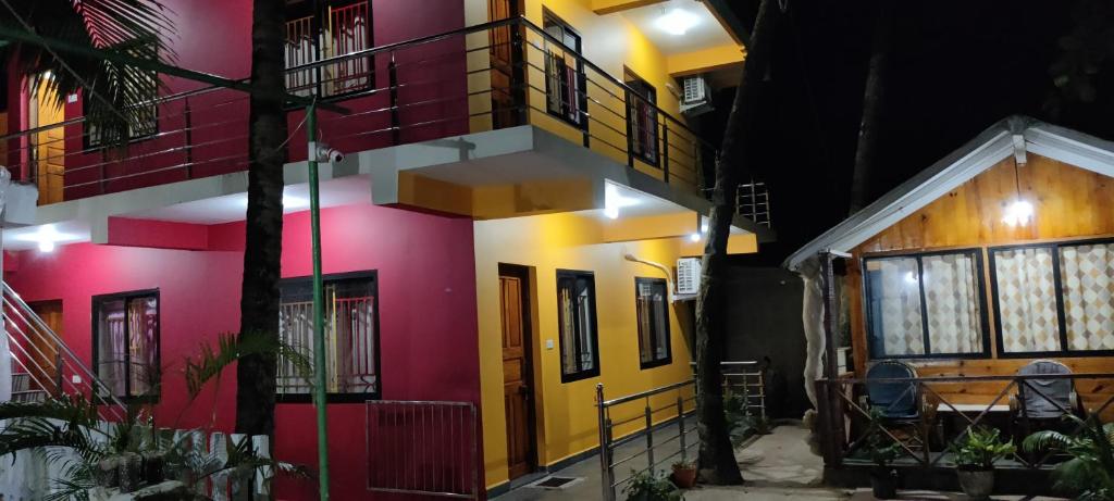 a house with colorful walls and windows at night at Rococo Pelton beach huts Palolem Beach goa in Palolem
