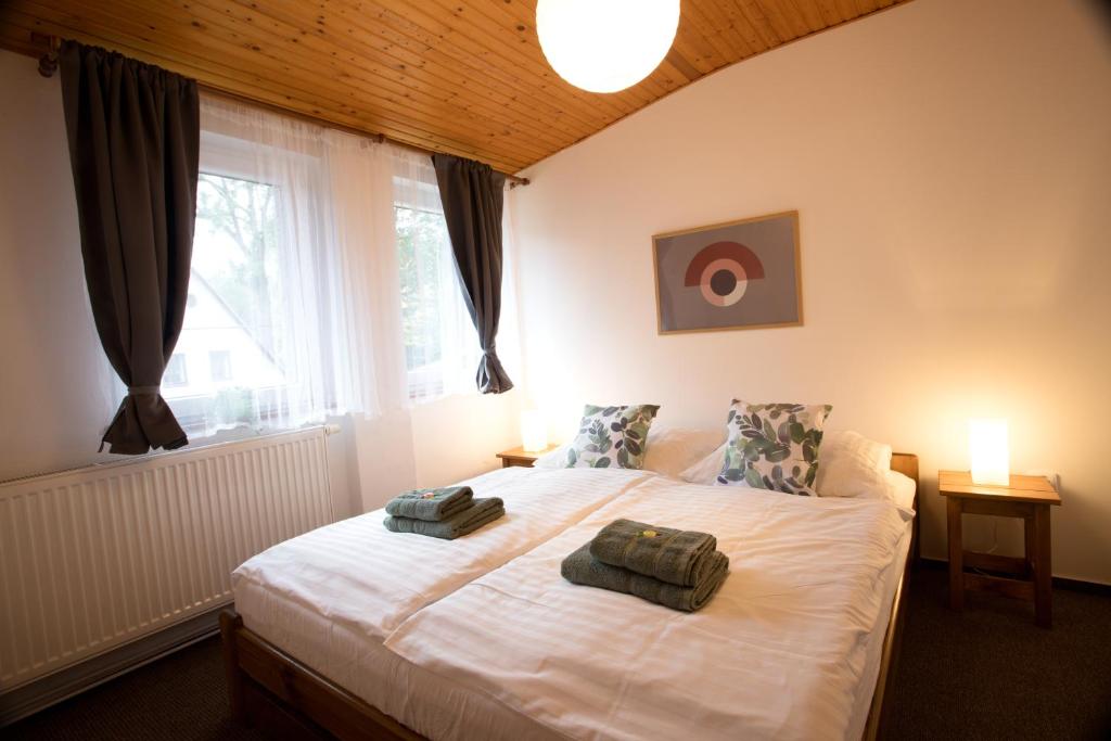 a bedroom with a bed with two towels on it at Apartmány Bramborka in Janov nad Nisou