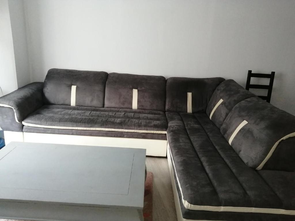 - un canapé brun dans le salon avec une table dans l'établissement à 2 pas du centre ville, à Parthenay