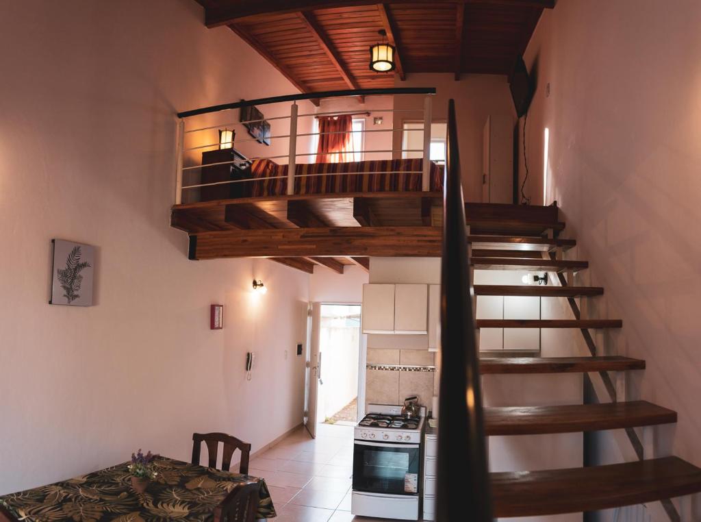 a spiral staircase in a room with a kitchen at Cálido Rincón in Villa Elisa