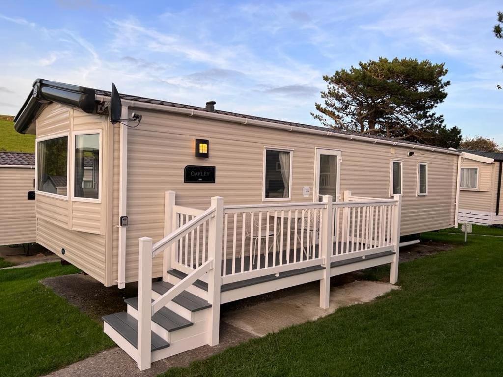 a mobile home with a porch and a deck at Newquay Bay Resort - Spacious - Sleeps 6 - Close to Porth Beach in Newquay