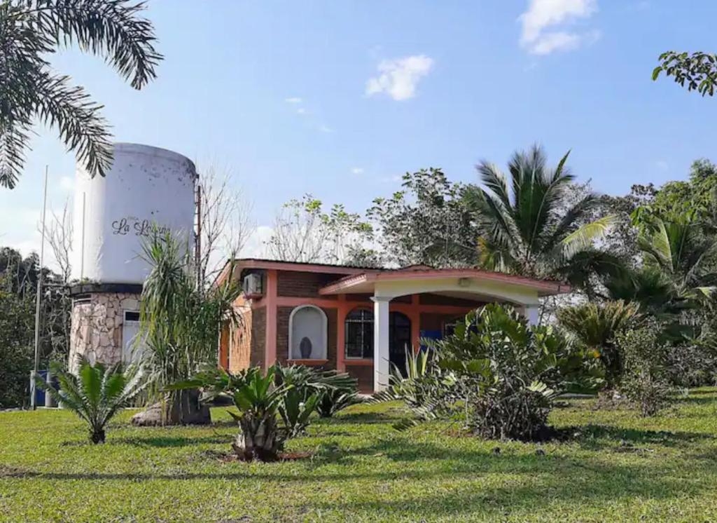 una pequeña casa con un silo en un campo en Finca La Laguna en Córdoba