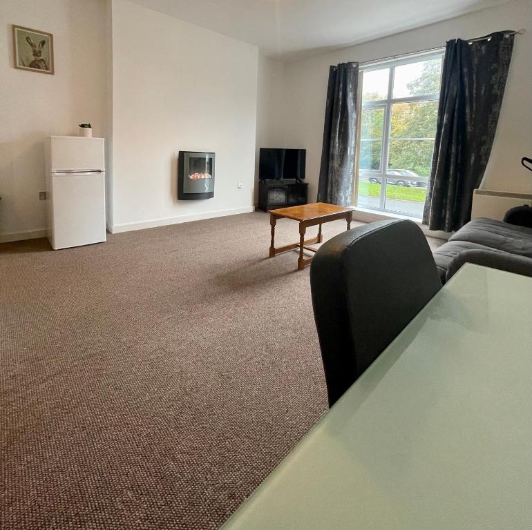 a living room with a couch and a table at Town centre flat in Darlington (free Parking) in Darlington