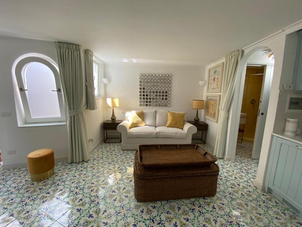 a living room with a couch and a table at Villa Sain Charming Suite in Anacapri