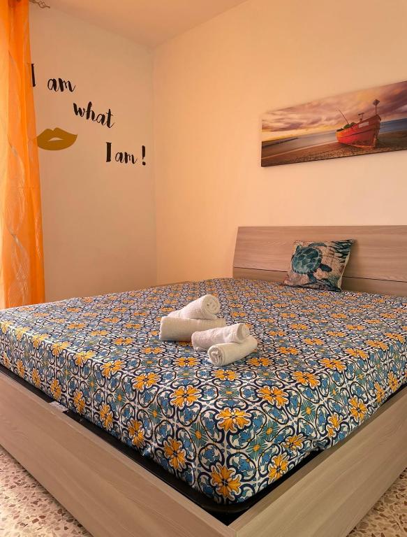 a bed with two stuffed animals laying on it at Appartamento Ponente in Balestrate