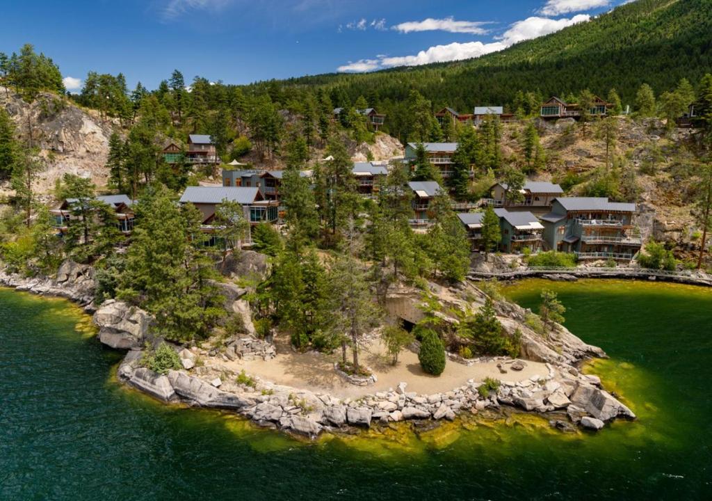 an aerial view of a house on an island in the water at The Outback Lakeside Vacation Homes in Vernon