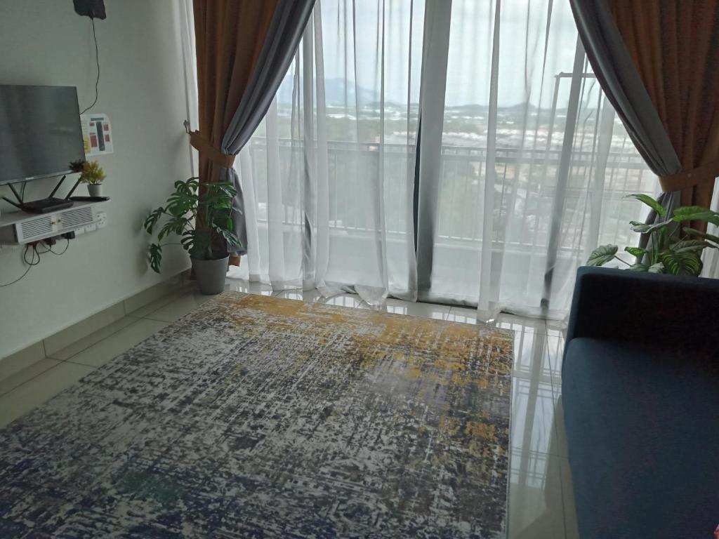 a living room with a large window and a rug at FZ Almyra Homestay in Kajang