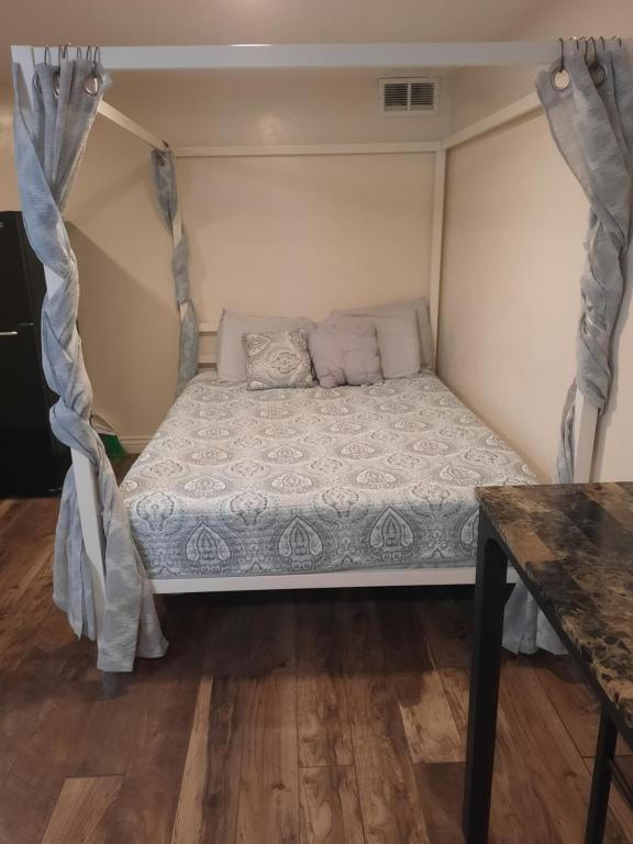 a small bed in a room with a table at Born to Wander in Cedar City