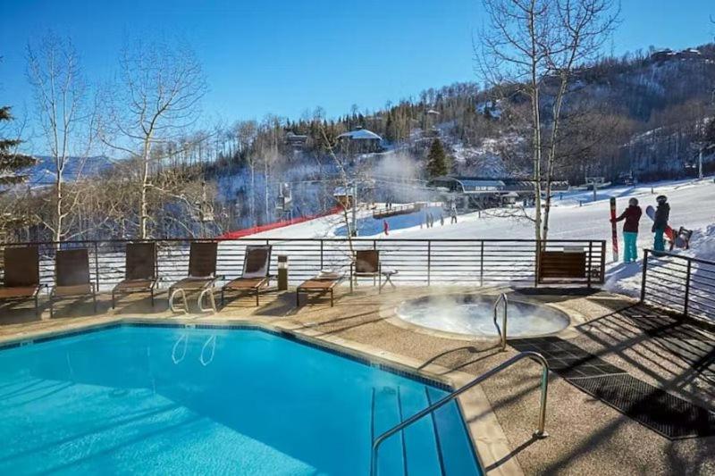 a swimming pool with a ski slope in the background at Snowmass Village, 3 Bedroom Condo at Chamonix, Ski-in Ski-out in Snowmass Village