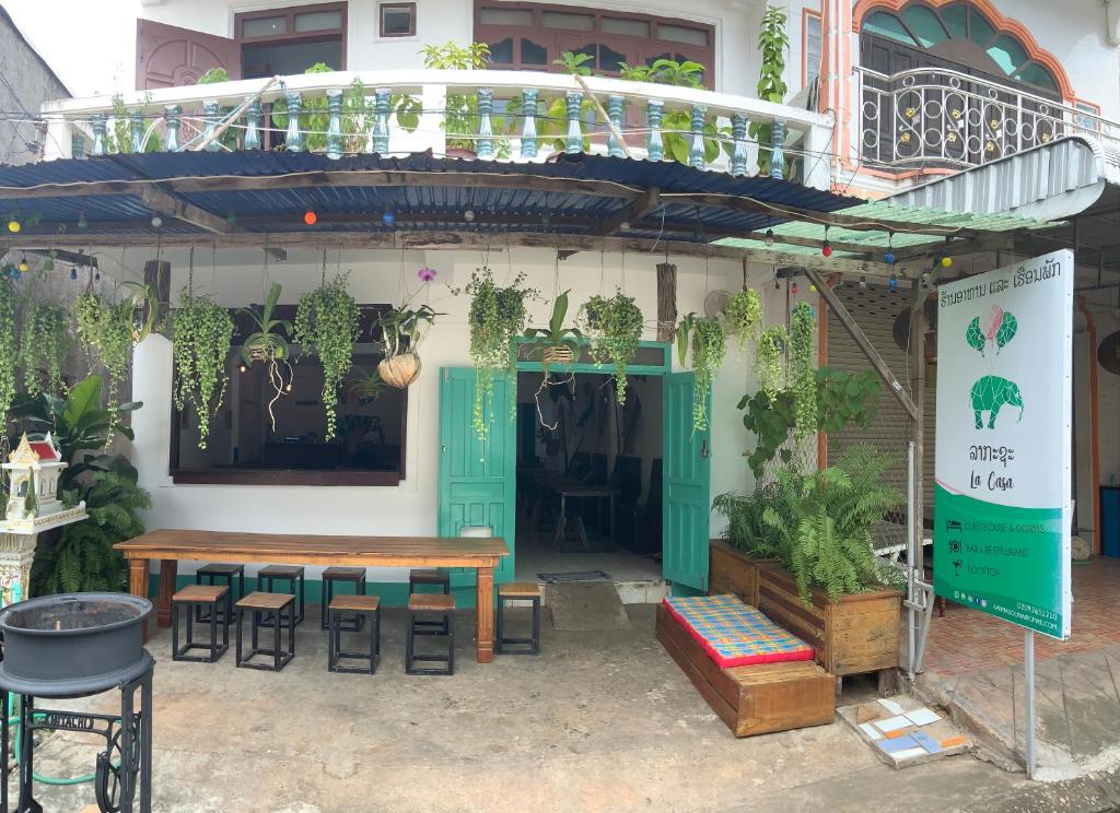 a patio with a table and chairs and a balcony at La Casa - Thakhek in Thakhek