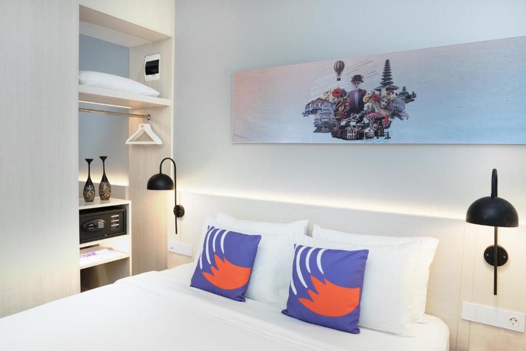 Postel nebo postele na pokoji v ubytování FOX Lite Hotel Samarinda