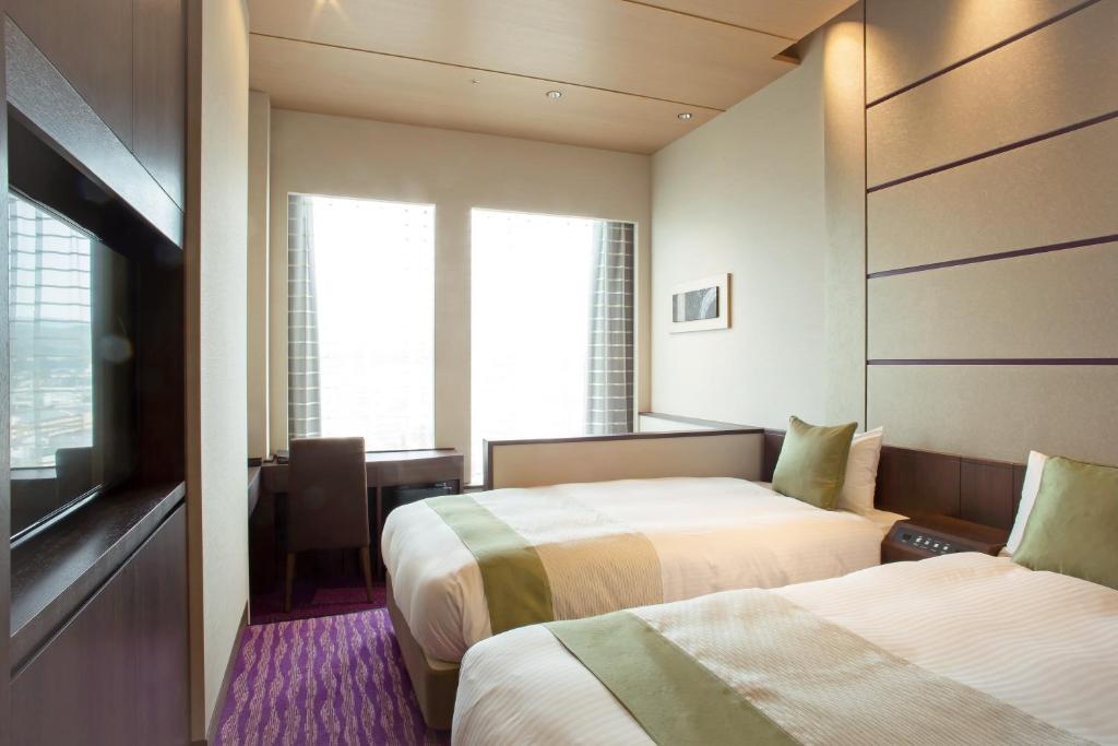 Postel nebo postele na pokoji v ubytování Hotel Keihan Kyoto Grande