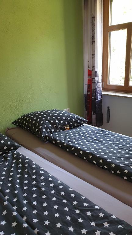 a bed in a room with a bedsheet on it at Ferienwohnung an der Begerburg in Dresden