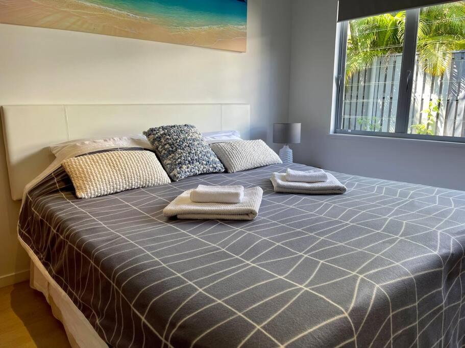 a large bed with two towels on top of it at Relax at Trinity Beach Getaway, Blue Lagoon, Trinity Beach in Trinity Beach