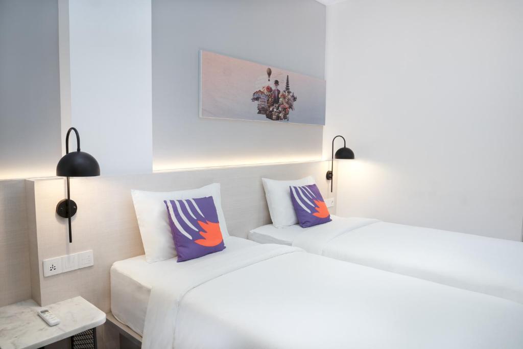 Postel nebo postele na pokoji v ubytování FOX Lite Hotel Samarinda