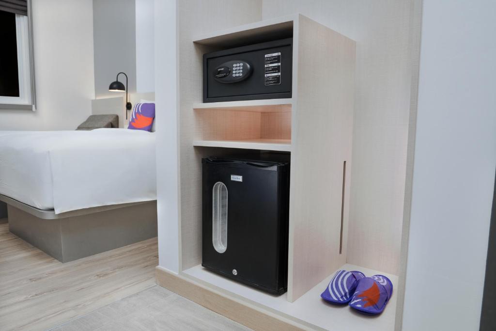 Postel nebo postele na pokoji v ubytování FOX Lite Hotel Samarinda