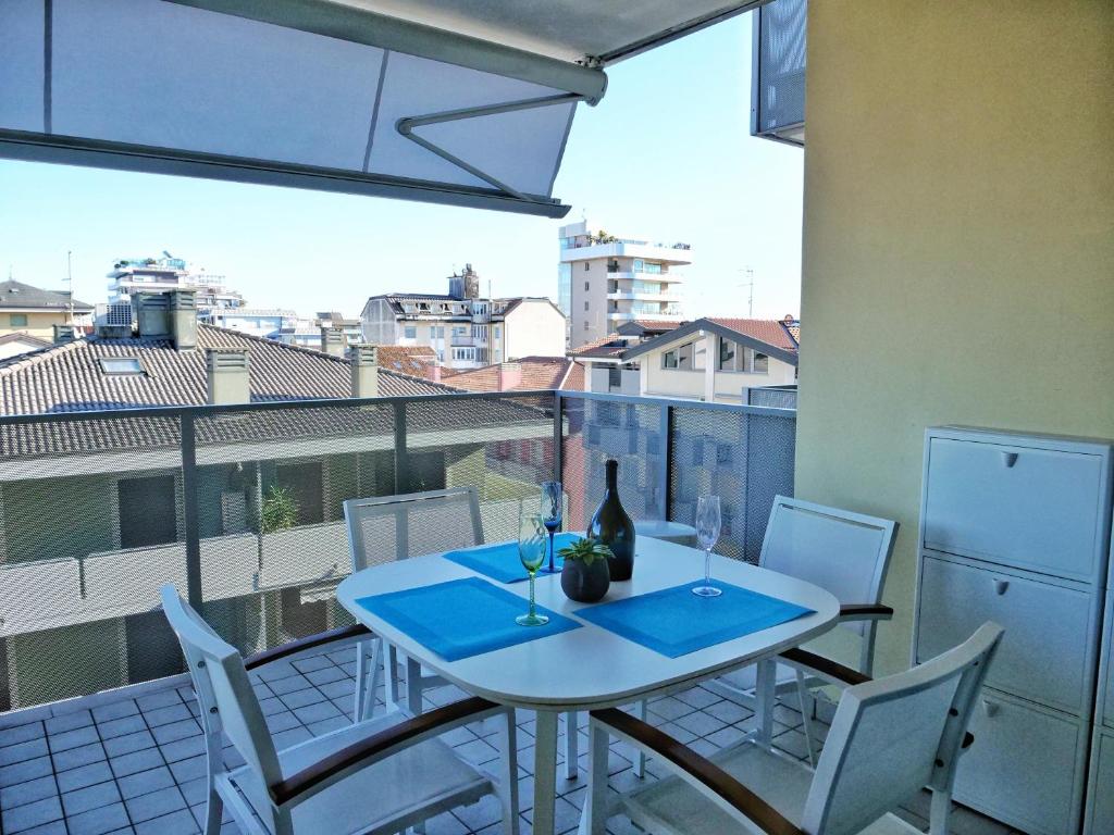 a table and chairs on a balcony with a view at Acquario sulla laguna EXCLUSIVE Luxury Apartment in Grado