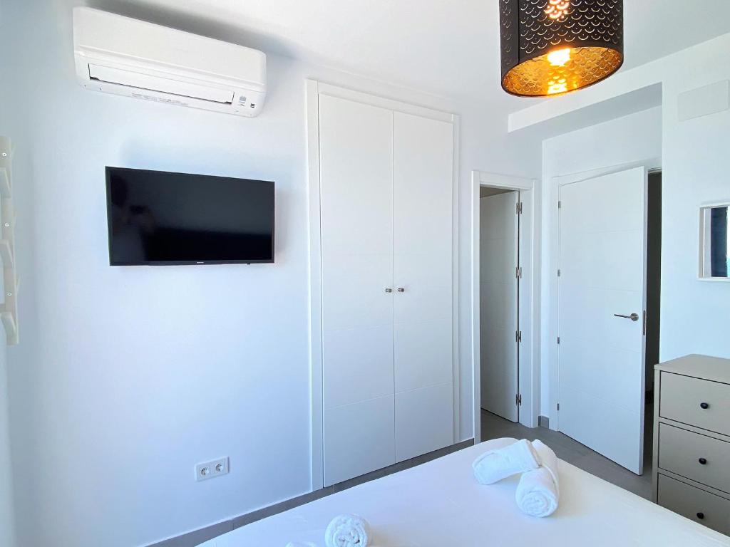 Televízia a/alebo spoločenská miestnosť v ubytovaní Terrazas de Ladera Duplex 2 Casasol