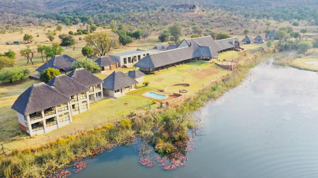 an aerial view of a house next to a river at Waterberg Game Lodge in Bela-Bela