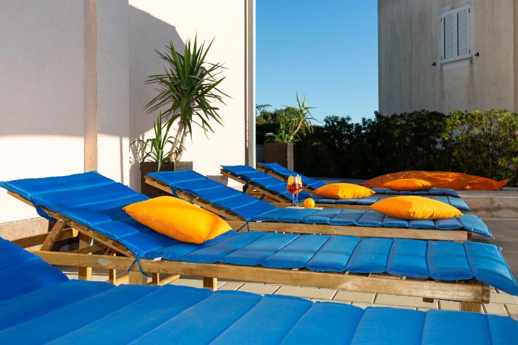 a row of blue and yellow pillows on a patio at "Mare et Sol" apartments in Sveti Filip i Jakov