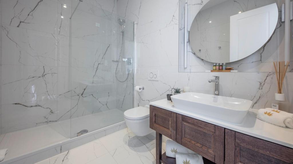 a bathroom with a sink and a toilet and a shower at Royal Neptun Hotel in Dubrovnik