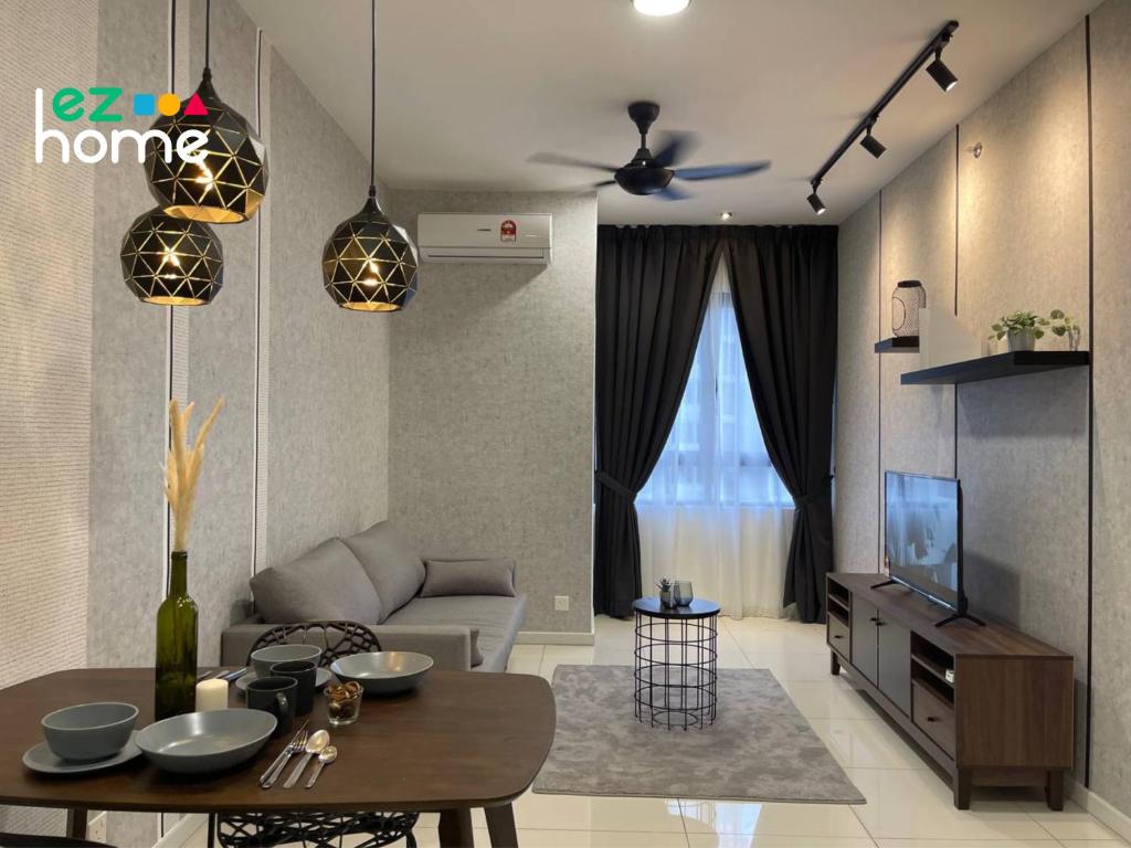 a living room with a table and a tv at Horizon Suites Ezhome in Sepang