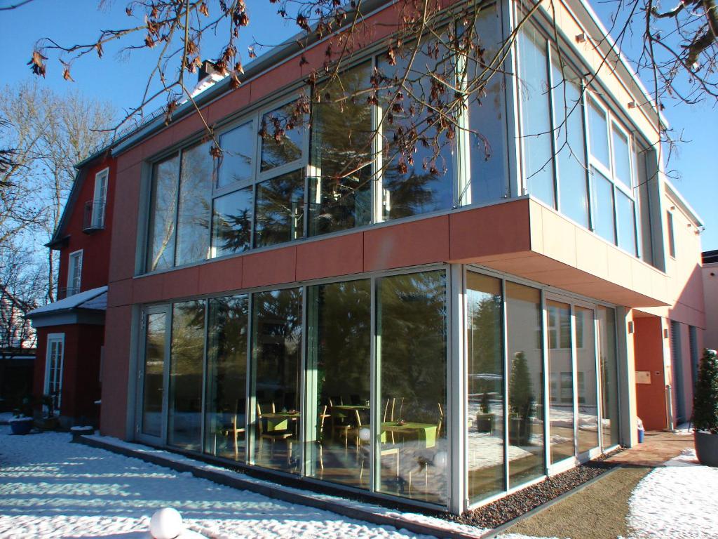 a building with large glass windows on the side of it at Rotenberg PT Hotel in Wittlich