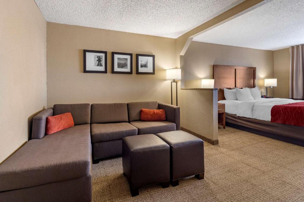 a hotel room with a couch and a bed at Comfort Inn & Suites Hays I-70 in Hays