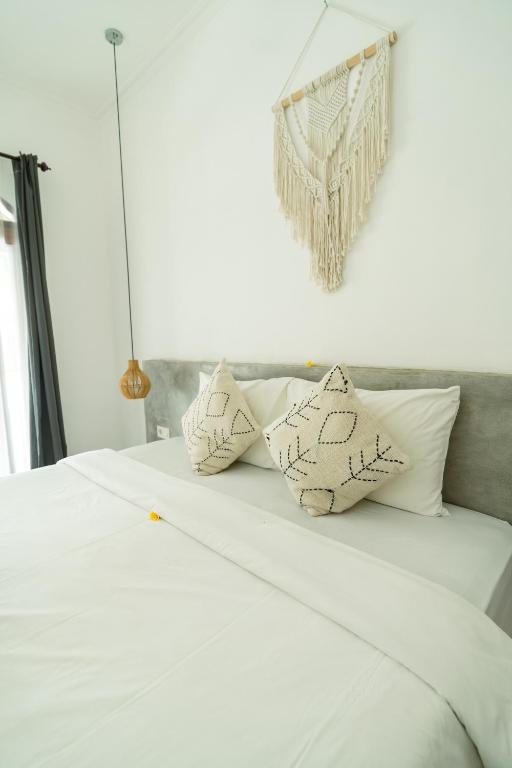 Postel nebo postele na pokoji v ubytování Suku Lifestyle Hotel & Villas