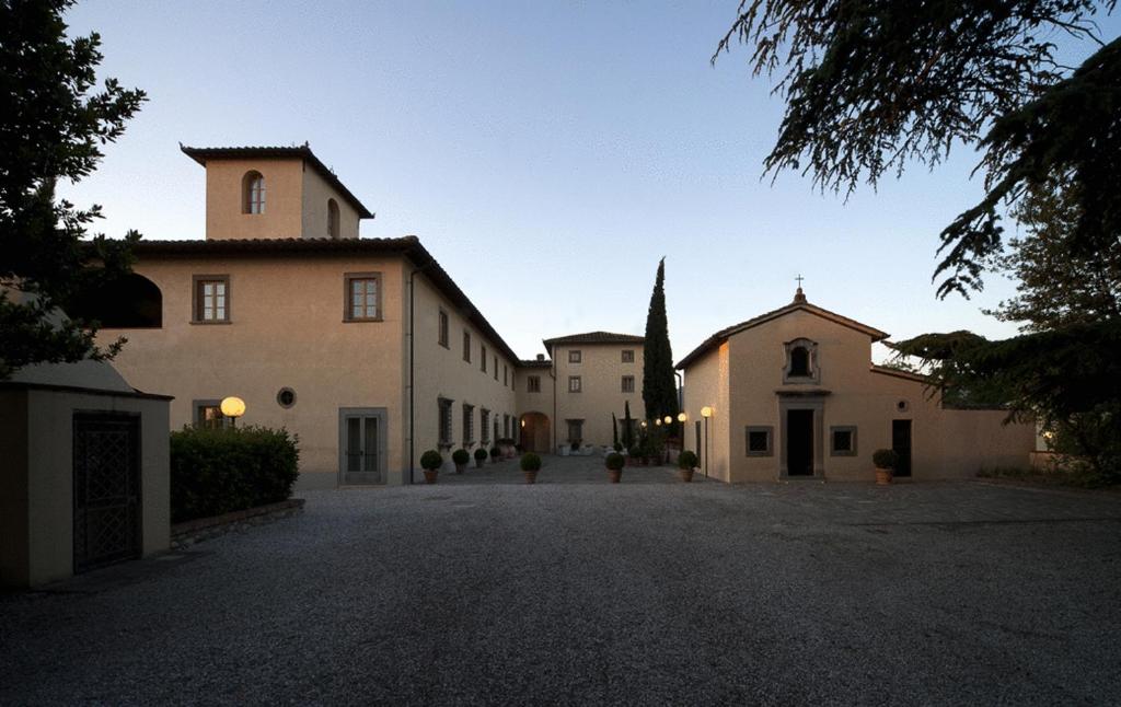 a group of buildings on a gravel driveway at Hotel 500 Firenze in Campi Bisenzio