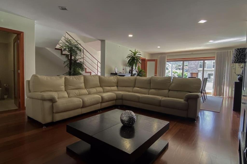 a living room with a couch and a table at Casa das Estrelas in Braga