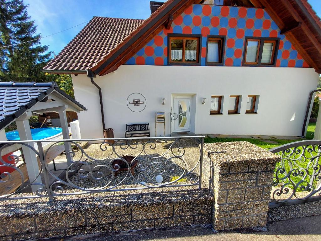 a house with a fence in front of it at Ferienwohnung Felsenblick in Albstadt