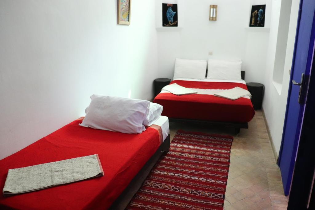 Postel nebo postele na pokoji v ubytování Hotel Dar El Qdima
