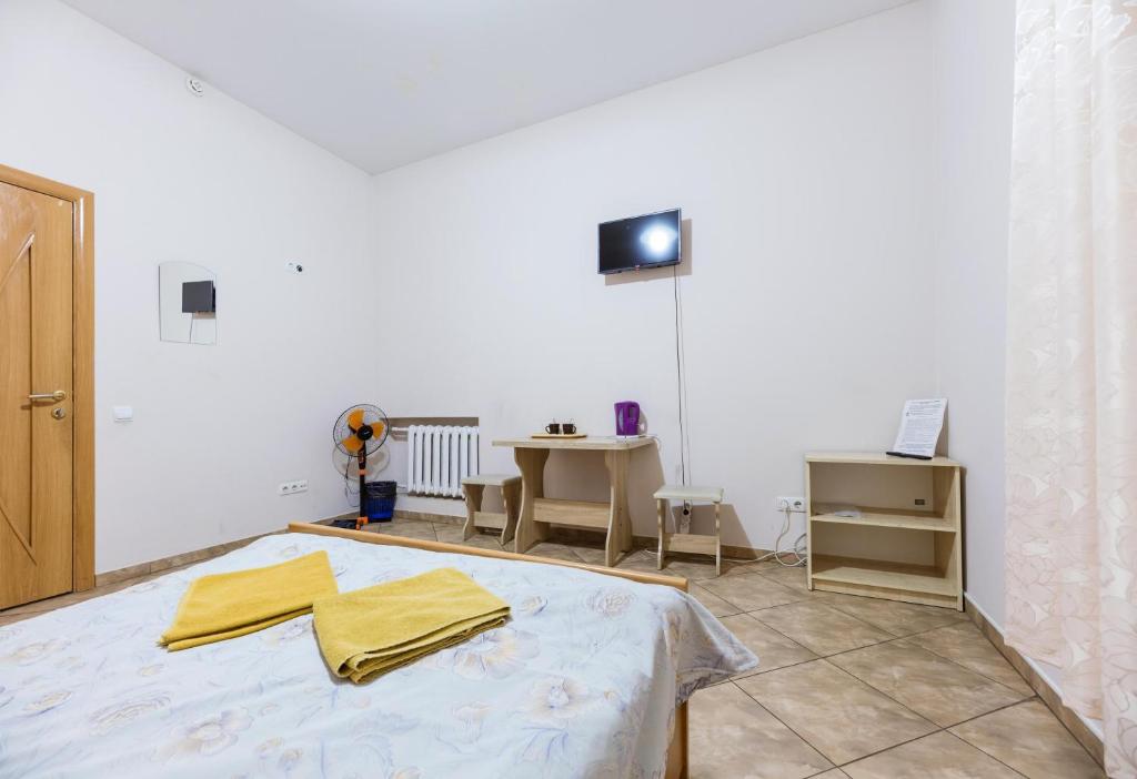 Postel nebo postele na pokoji v ubytování Mini Hotel near Arena City