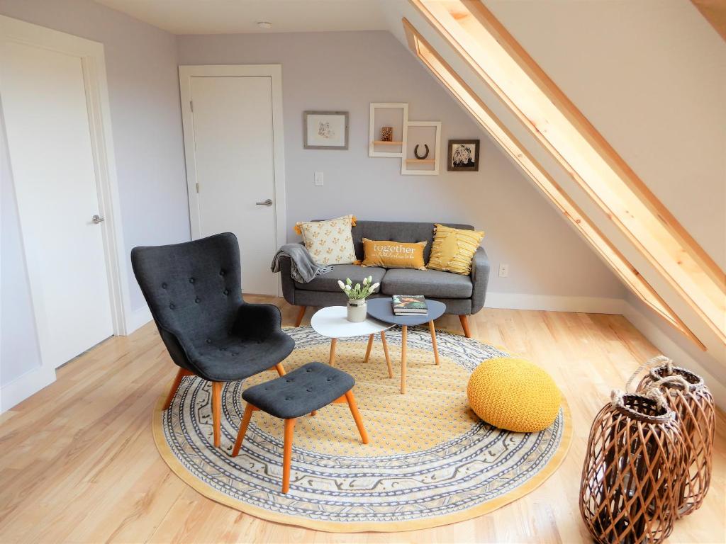 a living room with a chair and a couch at The Loft in Lyndeborough