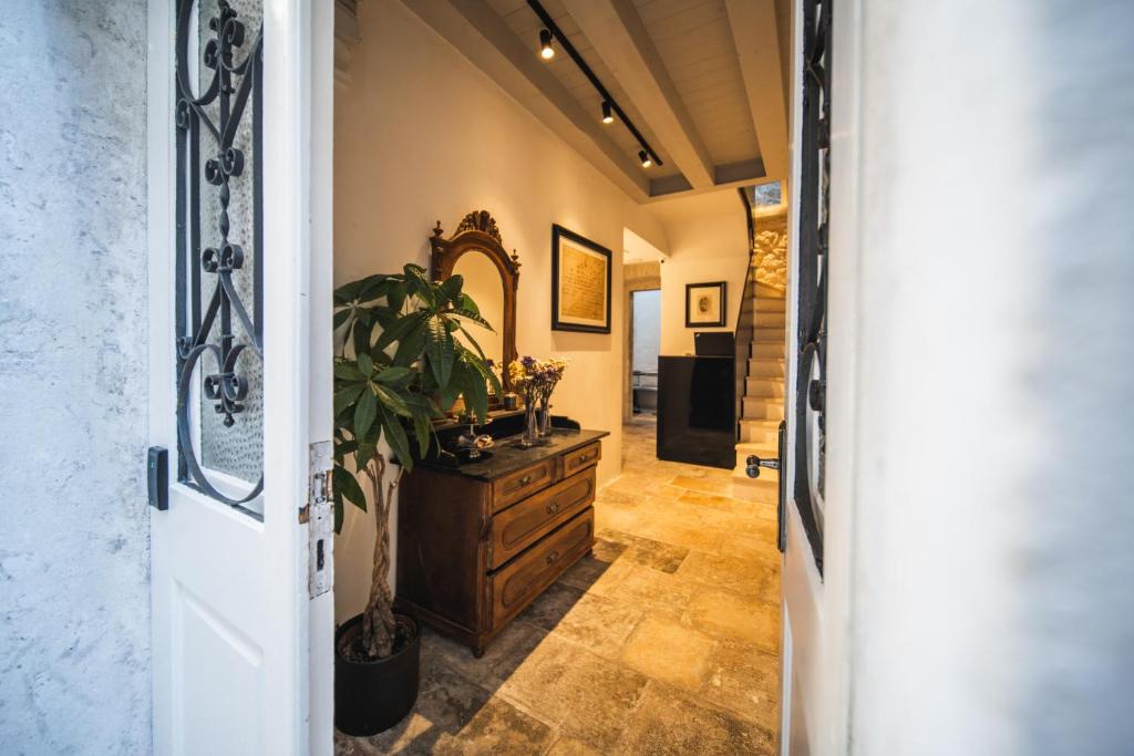 a hallway with a dresser and a mirror at Zuviteo Residence in Korčula