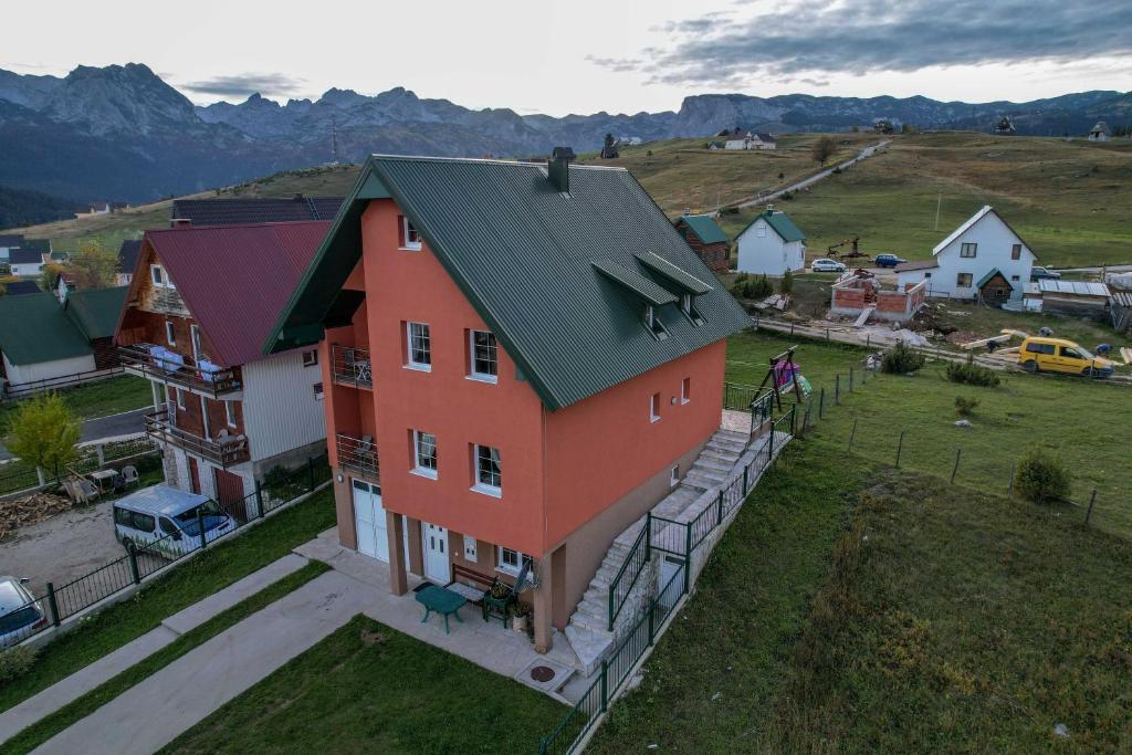 an overhead view of a house with a green roof at Apartments Millenium in Žabljak