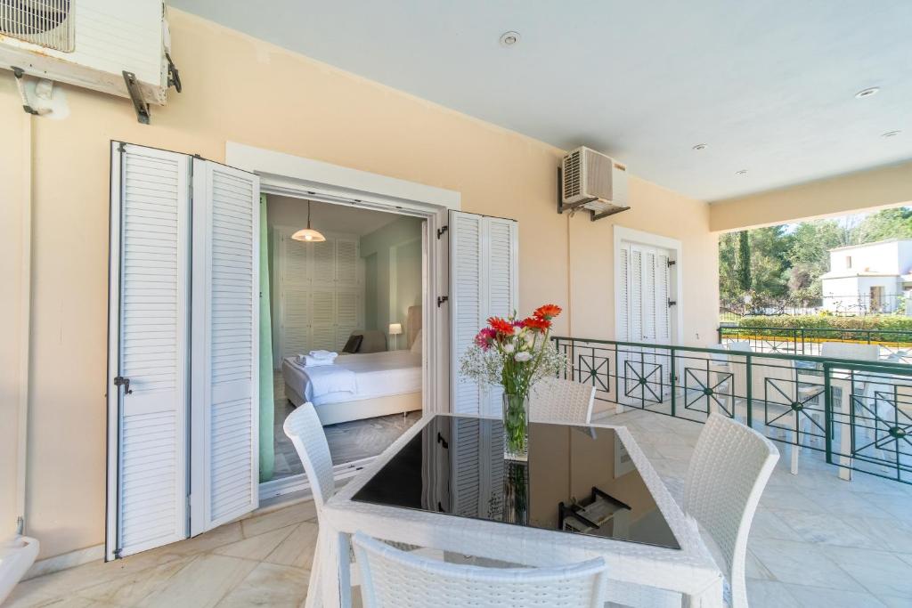 a dining room with a table and chairs and a bedroom at St Nicholas B4 Beach Garden View I in Dafnila