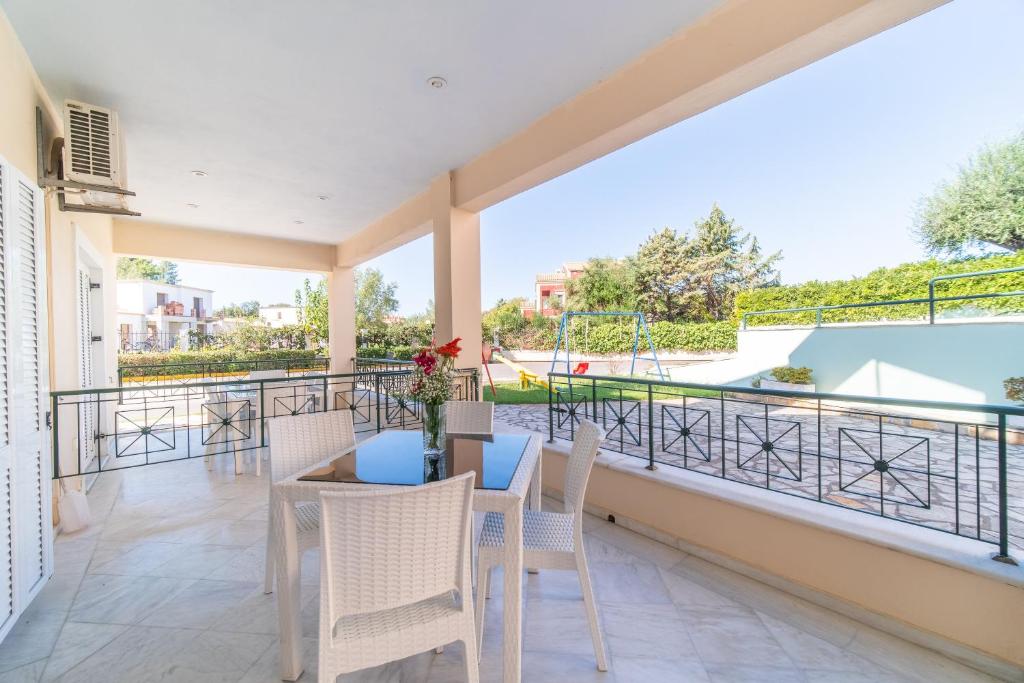 a patio with a table and chairs on a balcony at St Nicholas B4 Beach Garden View I in Dafnila