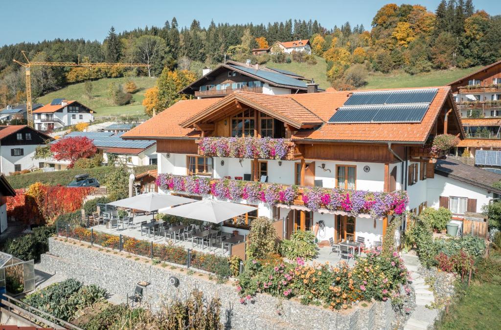 an aerial view of a house with solar panels on it at Ferienhaus und Landhaus Berger in Füssen