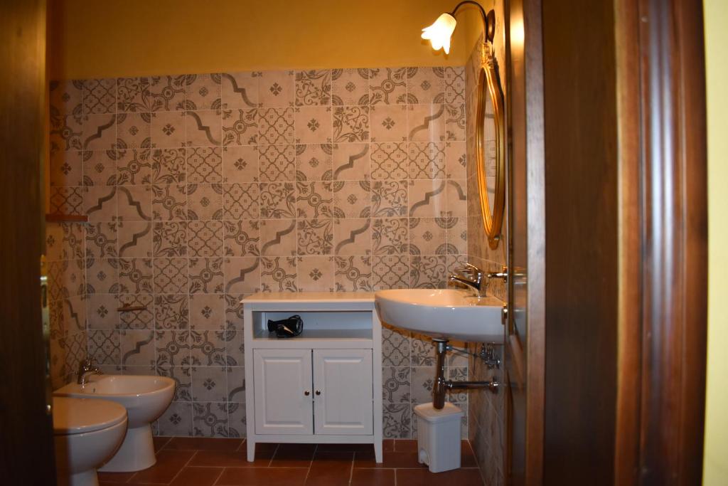łazienka z 2 toaletami i umywalką w obiekcie Agriturismo Il Santo w Greve in Chianti